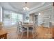 Elegant dining room featuring hardwood floors, a chandelier, and decoratively trimmed tray ceiling at 14727 Brannock Hills Dr, Charlotte, NC 28278