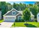 Charming home featuring a manicured lawn, two-car garage, and a mix of stone and gray plank exterior accents at 14727 Brannock Hills Dr, Charlotte, NC 28278