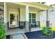 Inviting front porch with stone pillars, seating area, fresh landscaping, and the home's address clearly displayed at 14727 Brannock Hills Dr, Charlotte, NC 28278