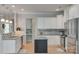A kitchen features pendant lighting, stainless steel appliances, tiled backsplash, and white cabinetry at 14727 Brannock Hills Dr, Charlotte, NC 28278