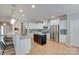 An eat-in kitchen features white cabinets, stainless steel appliances, and a granite countertop island at 14727 Brannock Hills Dr, Charlotte, NC 28278
