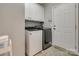Well-equipped laundry room featuring a modern washer and dryer with ample cabinet space at 14727 Brannock Hills Dr, Charlotte, NC 28278