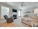 Inviting living room featuring hardwood floors, a fireplace, large windows, and comfortable seating arrangements at 14727 Brannock Hills Dr, Charlotte, NC 28278