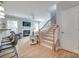 Cozy living room featuring a fireplace, staircase, and comfortable seating, perfect for relaxing and entertaining at 14727 Brannock Hills Dr, Charlotte, NC 28278