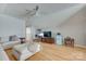 Bright living room with a large sofa, TV, desk, and plenty of natural light, creating a versatile living space at 14727 Brannock Hills Dr, Charlotte, NC 28278