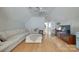 Spacious living room with a large sofa, TV, desk, and plenty of natural light, creating a versatile living space at 14727 Brannock Hills Dr, Charlotte, NC 28278