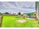 Spacious backyard features a patio, shade sail, trampoline, and ample green space for outdoor activities at 1583 Cold Creek Pl, Huntersville, NC 28078