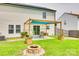 Lush backyard with a patio, fire pit, garden boxes, and shade sail provides an inviting outdoor space at 1583 Cold Creek Pl, Huntersville, NC 28078
