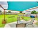 Green backyard features a patio, trampoline, privacy fence, and shade sail for relaxing outdoor fun at 1583 Cold Creek Pl, Huntersville, NC 28078