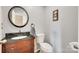 Powder room featuring a modern vanity with a black granite counter top and a round mirror at 1583 Cold Creek Pl, Huntersville, NC 28078