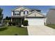 Charming two-story home featuring a manicured lawn and a spacious two-car garage at 1583 Cold Creek Pl, Huntersville, NC 28078