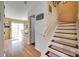 Hallway with hardwood flooring leads to an eat-in kitchen with an outdoor dining area at 1583 Cold Creek Pl, Huntersville, NC 28078