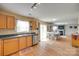 Bright kitchen featuring wood cabinets, stainless steel appliances and laminate floors at 1583 Cold Creek Pl, Huntersville, NC 28078
