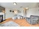 Cozy living room with fireplace, wood floors, and comfortable seating arrangement at 1583 Cold Creek Pl, Huntersville, NC 28078