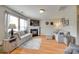 Open-concept living room features hardwood floors, neutral paint, fireplace, and abundant natural light at 1583 Cold Creek Pl, Huntersville, NC 28078