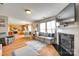 Bright living room with fireplace, open floorplan, and view into kitchen dining area at 1583 Cold Creek Pl, Huntersville, NC 28078