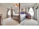 Spacious main bedroom featuring a four-poster bed and ample natural light at 1583 Cold Creek Pl, Huntersville, NC 28078