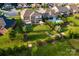 Aerial view of a well-landscaped backyard featuring a pool, patio, fire pit, and lush greenery, perfect for relaxation at 159 Holly Ridge Dr, Mooresville, NC 28115