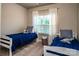 Comfortable ' room with twin beds, natural light and playful blue bedding at 159 Holly Ridge Dr, Mooresville, NC 28115