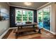 Inviting dining area with rustic table, bench, and large windows offering a scenic view at 159 Holly Ridge Dr, Mooresville, NC 28115