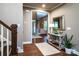 Inviting foyer with hardwood floors, a staircase, and decorative mirror and table at 159 Holly Ridge Dr, Mooresville, NC 28115