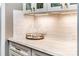 Elegant kitchen counter with marble surface, under-cabinet lighting, and decorative glassware at 159 Holly Ridge Dr, Mooresville, NC 28115