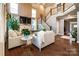 Open living room featuring hardwood floors, large windows, and a cozy fireplace at 159 Holly Ridge Dr, Mooresville, NC 28115