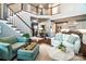 Bright living room with high ceilings, staircase, and open floor plan to the modern kitchen at 159 Holly Ridge Dr, Mooresville, NC 28115