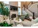 Cozy living room features a fireplace, large windows, and elegant staircase to the second floor at 159 Holly Ridge Dr, Mooresville, NC 28115