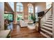 Bright and airy living room with hardwood floors, a staircase, and large windows at 159 Holly Ridge Dr, Mooresville, NC 28115