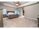 Serene bedroom with a tray ceiling, comfortable bed, and neutral colors at 159 Holly Ridge Dr, Mooresville, NC 28115