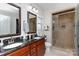 Luxurious bathroom with double sinks, granite counters, and a glass-enclosed shower at 16142 Commodore Dr, Lancaster, SC 29720
