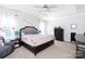 Serene main bedroom featuring a tray ceiling, ceiling fan and neutral tones at 16142 Commodore Dr, Lancaster, SC 29720