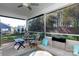 Relaxing screened porch with ceiling fan, plush seating, and wooded views at 16142 Commodore Dr, Lancaster, SC 29720