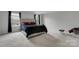 Well-lit bedroom with large windows, a bed, and neutral decor for a tranquil setting at 16404 Wavenly House Dr, Charlotte, NC 28273