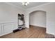 Entryway with wood floors, archway, white trim, and hall tree with bench at 16404 Wavenly House Dr, Charlotte, NC 28273