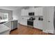 Well-lit kitchen with stainless steel appliances, white cabinets, and modern countertops at 16404 Wavenly House Dr, Charlotte, NC 28273