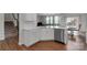 Bright kitchen with white cabinets, stainless steel appliances and a view of the dining area at 16404 Wavenly House Dr, Charlotte, NC 28273
