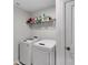 Bright laundry room with a modern, front-loading washer and dryer set at 16404 Wavenly House Dr, Charlotte, NC 28273