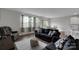 Open-concept living space featuring seating, large windows, and neutral colors at 16404 Wavenly House Dr, Charlotte, NC 28273