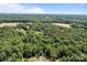 Wide aerial shot of the property, showing its vast green expanse and wooded areas at 168 Pleasant Creek Dr, Cleveland, NC 27013