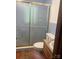 Bathroom featuring a glass enclosed shower, tile floors and walls, and wooden vanity at 168 Pleasant Creek Dr, Cleveland, NC 27013