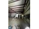 This is a large garage with metal beams and a storage loft, offering ample space for vehicles or equipment at 168 Pleasant Creek Dr, Cleveland, NC 27013