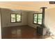 Spacious living room featuring hardwood floors, large windows, and a rustic wood burning stove at 168 Pleasant Creek Dr, Cleveland, NC 27013