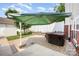 Backyard features a paved patio, hot tub, white fence, and mature tree at 18137 Amberwood Glen Dr, Cornelius, NC 28031