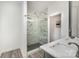 This bathroom features a glass shower with black-and-white tile, plus a gray vanity at 18137 Amberwood Glen Dr, Cornelius, NC 28031