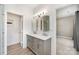The bathroom has a gray vanity with double sinks, plus a shower with white tile at 18137 Amberwood Glen Dr, Cornelius, NC 28031