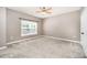 A bedroom with carpet and neutral-colored walls has a window and closet with folding doors at 18137 Amberwood Glen Dr, Cornelius, NC 28031