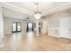 Well-lit living room featuring modern chandelier, wood floors, and open layout at 18137 Amberwood Glen Dr, Cornelius, NC 28031