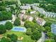 Aerial view of a community with lush greenery, a pool, a pond, and a tennis court at 18817 Nautical Dr # 302, Cornelius, NC 28031